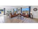Bright and airy living room featuring neutral walls, stylish decor, and expansive windows at 6899 Broad River Ave, Land O Lakes, FL 34638
