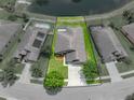 An aerial view showing the home's location with a pond view and proximity to neighboring properties at 6957 Boulder Run Loop, Wesley Chapel, FL 33545