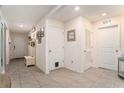 Bright entryway features tile floors, a coat rack, and neutral walls, creating a welcoming atmosphere at 7639 Broad Pointe Dr, Zephyrhills, FL 33540
