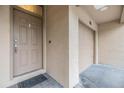 Exterior showcasing front door and garage of a home with beige walls, a doormat, and a house number at 820 Normandy Trace Rd # 820, Tampa, FL 33602