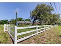 Well-maintained front yard with a white fence showcasing the property's boundary at 9918 Davis Rd, Tampa, FL 33637
