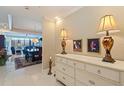 Elegant foyer featuring a dresser with decorative lamps and artwork, leading to the dining and living areas at 1 Beach Se Dr # 2011, St Petersburg, FL 33701