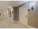 Condo hallway featuring neutral decor, carpet flooring, and a well-lit entrance door with unit number 2011 at 1 Beach Se Dr # 2011, St Petersburg, FL 33701
