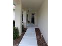 Covered walkway leading to the front door offering a welcoming approach to the residence at 11541 Orleans Ln, Port Richey, FL 34668