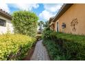 A brick path meanders through lush landscaping, enhancing the curb appeal of this inviting home at 11551 Callisia Dr, Odessa, FL 33556
