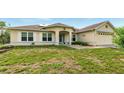 Charming single-story home featuring a well-maintained lawn and inviting curb appeal at 15348 Glossy Ibis Rd, Weeki Wachee, FL 34614