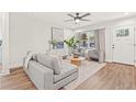 Inviting living room with wood-look floors, large window, gray seating, and modern decor at 1713 W Saint John St, Tampa, FL 33607