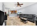 Comfortable living room featuring an open layout, travertine flooring and access to the kitchen at 1881 N Hercules Ave # 602, Clearwater, FL 33765