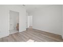 Bright bedroom with hardwood flooring, neutral walls, and ensuite bathroom at 303 15Th N St, St Petersburg, FL 33705