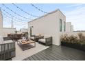 Stylish rooftop patio with modern furniture, string lights, and decorative plants for outdoor entertaining at 321 15Th N St, St Petersburg, FL 33705