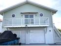 Two-story coastal home featuring a balcony and two-car garage at 3312 Holly Springs Dr, Hernando Beach, FL 34607
