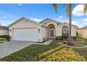 Charming single Gathering home with a well-manicured lawn and beautiful landscaping at 4411 Whitton Way, New Port Richey, FL 34653