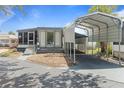 Charming single-story home featuring a covered carport and a cozy screened-in porch at 4851 W Gandy Blvd # B1L8, Tampa, FL 33611