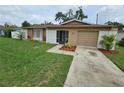 Charming single-story home featuring a well-manicured front yard and attached garage at 505 Innergary Pl, Valrico, FL 33594