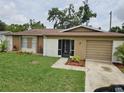 Charming single-story home featuring a well-manicured front yard and attached garage at 505 Innergary Pl, Valrico, FL 33594