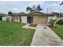 Charming single-story home featuring a well-manicured front yard and attached garage at 505 Innergary Pl, Valrico, FL 33594