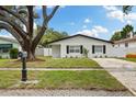 Charming single-story home featuring a well-manicured lawn and gravel driveway at 621 89Th N Ave, St Petersburg, FL 33702