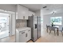 Open kitchen layout with stainless steel refrigerator and adjacent dining area at 6738 Criswell N Ave, St Petersburg, FL 33709