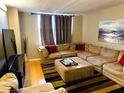 Comfortable living room with sectional sofa, modern art, and plenty of space to relax at 701 S Madison Ave # 515, Clearwater, FL 33756