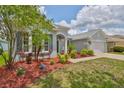 Well-maintained home exterior with lush landscaping, a two-car garage, and lovely curb appeal at 7114 Cromwell Park Ln, Apollo Beach, FL 33572