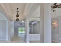 Elegant living room with tiled floors, decorative columns, and a view of the screened-in pool at 7114 Cromwell Park Ln, Apollo Beach, FL 33572