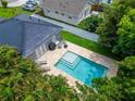 An aerial view of a home with a private in-ground pool, patio, and lush backyard at 719 58Th S St, Gulfport, FL 33707