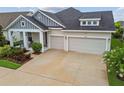 Charming single Gathering home with a three-car garage, inviting front porch, and beautiful landscaping at 7616 Paradiso Dr, Apollo Beach, FL 33572