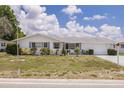 Charming single-story home featuring a well-maintained lawn and attached garage at 8014 Lotus Dr, Port Richey, FL 34668