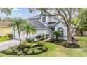 Inviting two-story home with a well-maintained lawn, mature trees and an attached two-car garage at 9806 Bennington Dr, Tampa, FL 33626