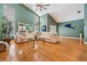 Open living room features high ceilings, hardwood floors, and large windows for natural light at 9806 Bennington Dr, Tampa, FL 33626