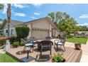 Cozy outdoor seating area on a wooden deck with a charming fire pit, perfect for relaxing or entertaining at 1 Mandarin Ter, Safety Harbor, FL 34695
