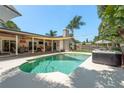 Gorgeous pool area with hot tub, covered patio, and outdoor seating perfect for entertaining at 1 Mandarin Ter, Safety Harbor, FL 34695