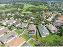 Beautiful aerial view of a community with lake and golf course close by at 1135 Millbrook Cir, Bradenton, FL 34212