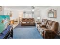Cozy living room with comfortable seating, carpet flooring, and natural light at 11762 Barb Ct, Seminole, FL 33778