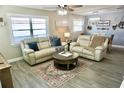 Cozy living room featuring neutral tones, hardwood floors, and comfortable seating at 135 Emerald Ln, Largo, FL 33771