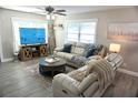 Inviting living area with hardwood floors, natural light, and comfortable furnishings at 135 Emerald Ln, Largo, FL 33771