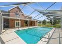 Enjoy this refreshing in-ground pool surrounded by a screened enclosure for outdoor relaxation at 15420 Aubrey Ave, Spring Hill, FL 34610