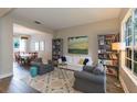 Bright living room featuring bookshelves, hardwood floors, and comfortable seating at 17734 Long Ridge Rd, Tampa, FL 33647