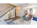 Inviting living room showcasing a staircase, hardwood floors, and comfortable seating arrangements at 17734 Long Ridge Rd, Tampa, FL 33647