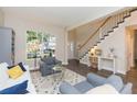 Cozy living room featuring hardwood floors, large window, and staircase at 17734 Long Ridge Rd, Tampa, FL 33647