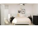 Cozy bedroom with black and white decor, complemented by soft lighting and a ceiling fan at 1805 Tropical Oasis Ave, Plant City, FL 33565