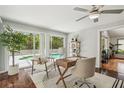 Bright office space with pool view through large windows, hardwood floors, and modern furnishings at 18914 Geraci Rd, Lutz, FL 33548