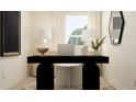 Modern home office setup with a black desk, white chair, and neutral decor at 210 Se 27Th St, Ruskin, FL 33570