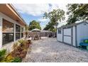 Spacious backyard featuring a gravel area, outdoor seating, and a storage shed at 2135 Pocahontas Dr, Largo, FL 33774