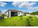 Large backyard featuring a screened patio and fresh landscaping, great for outdoor living at 21395 Southern Charm Dr, Land O Lakes, FL 34637
