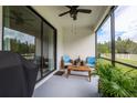 Relaxing screened patio with comfortable seating, perfect for enjoying the outdoors at 21395 Southern Charm Dr, Land O Lakes, FL 34637