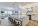 Spacious kitchen with a large island, marble countertops, and sleek white cabinetry at 2388 Oakwood Preserve Dr, Wesley Chapel, FL 33543