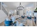 Bright and open living room featuring a fireplace, modern chandelier, and stylish decor at 2388 Oakwood Preserve Dr, Wesley Chapel, FL 33543