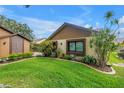 Attractive landscaping featuring mature plants, manicured flowerbeds, and healthy lawn on a sunny day at 2475 Bay Berry Dr, Clearwater, FL 33763