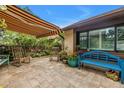 Relaxing patio with awning, adorned with comfortable seating, potted plants and bench, creating a peaceful outdoor retreat at 2475 Bay Berry Dr, Clearwater, FL 33763